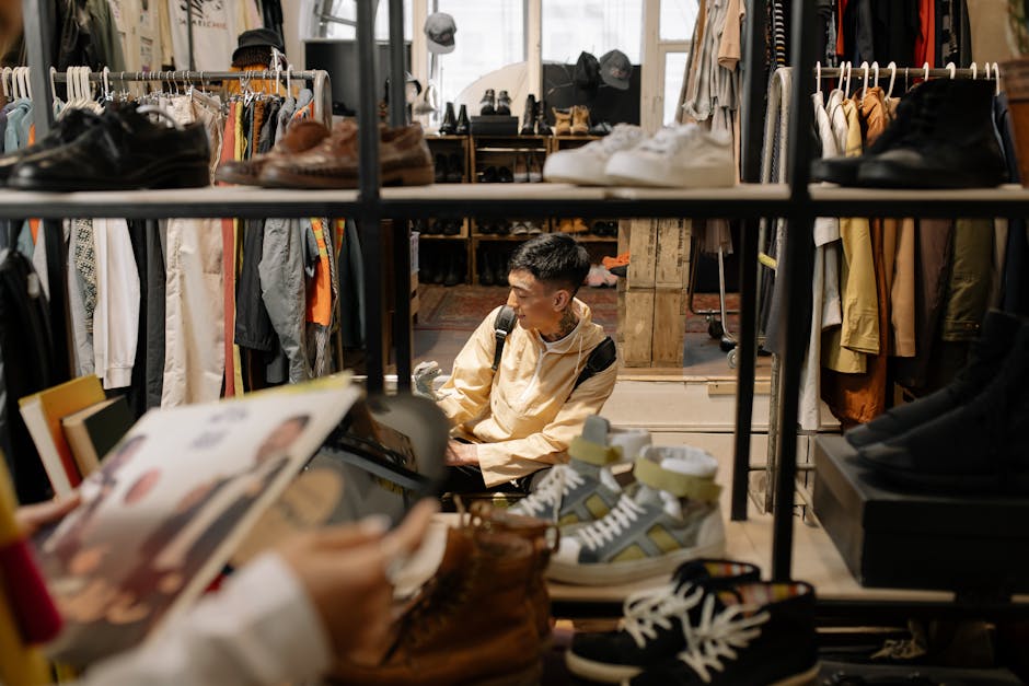 An adult man browsing items in a stylish, well-organized vintage clothing store.
